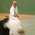 Sensei Walters throwing someone whilst removing a wooden sword from their grasp