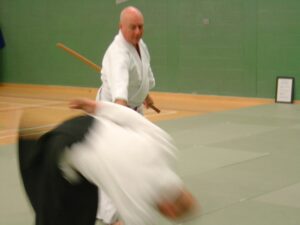 Sensei Walters throwing someone whilst removing a wooden sword from their grasp