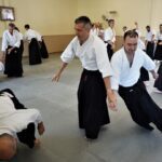Three people training together at the headquarters dojo