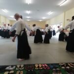 Students being tested for stability the "arms out from side and bending" exercise