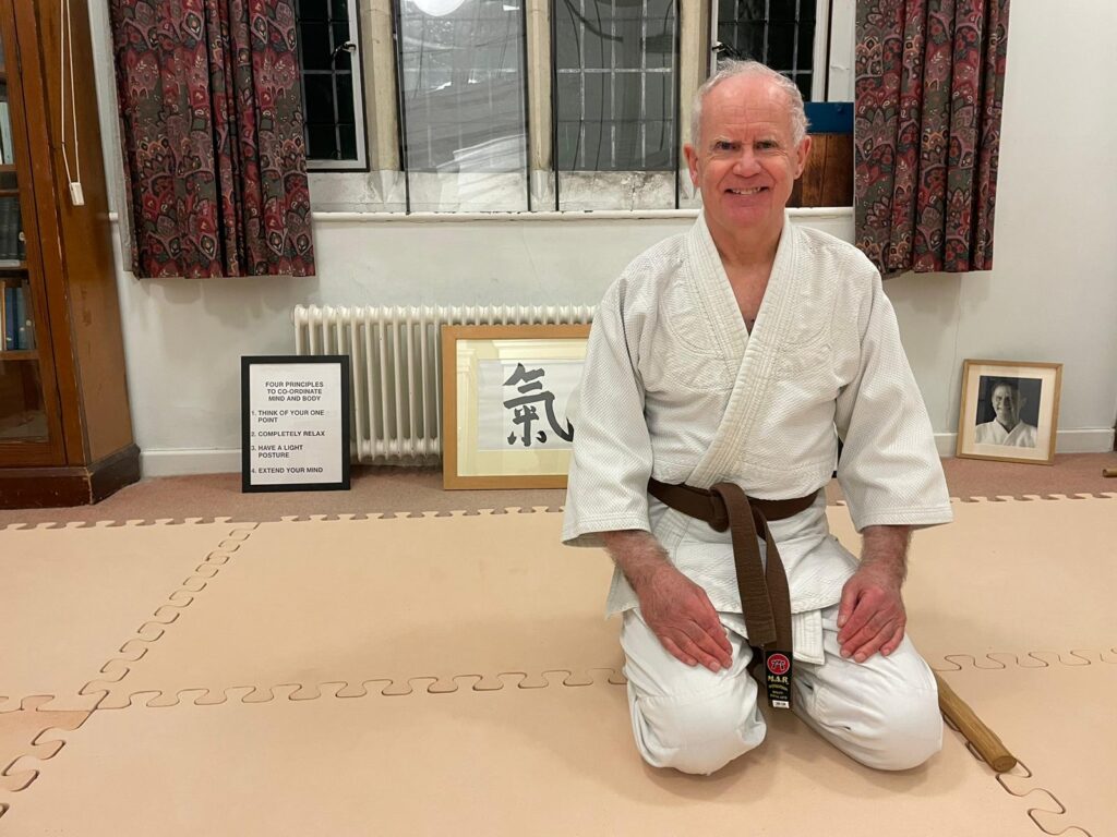 Tim Unsworth, age 70 years old, celebrates his gradings success