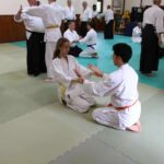 Younger students practising their kneeling exercise.