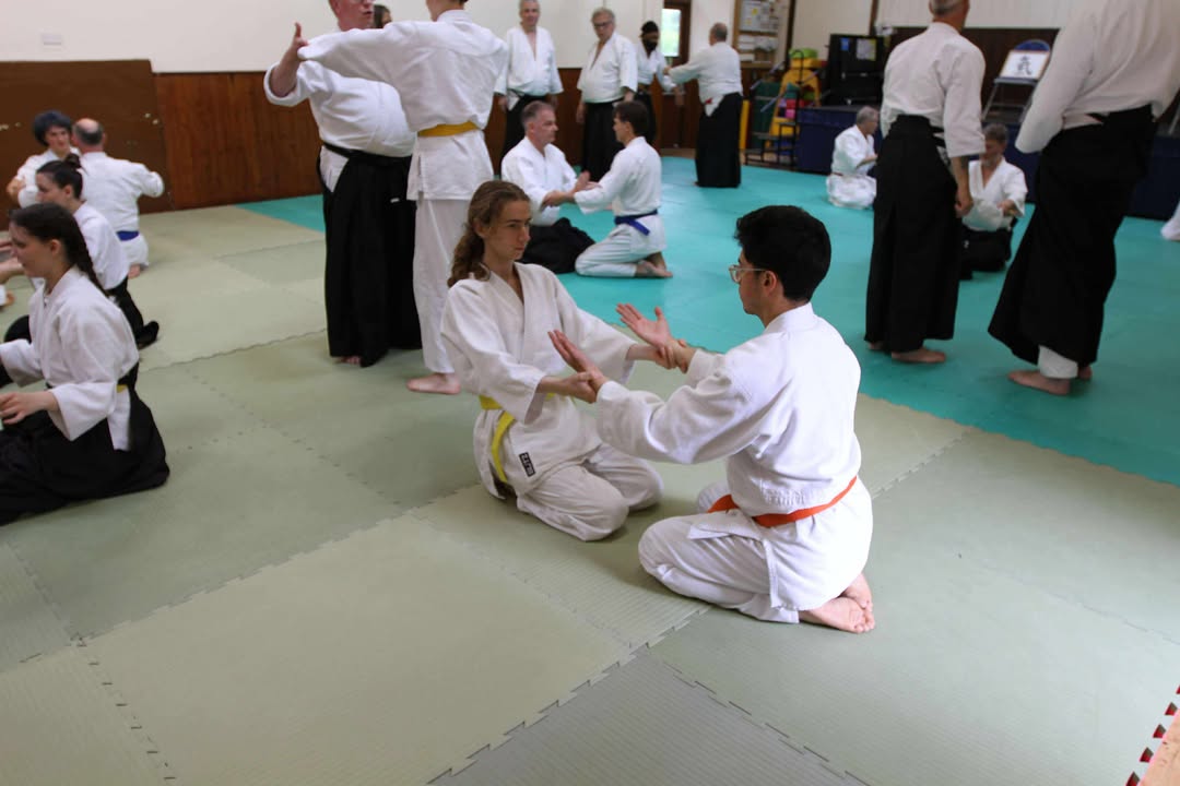Younger students practising their kneeling exercise.